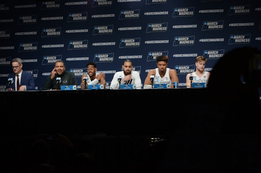 <p>Head coach Ed Cooley (second from left) and members of the Providence Friars men's basketball team answer questions from the media following the team's 66-57 victory over South Dakota State Thursday.</p>