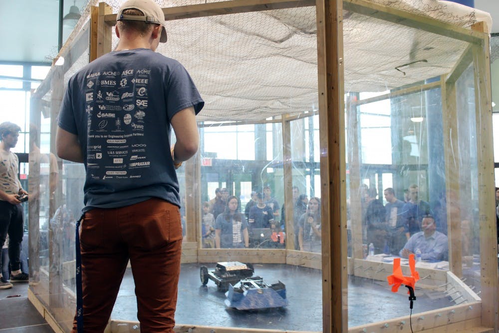 <p>Junior biomedical engineering major Andrew Hoke controls his bot from outside the arena.</p>