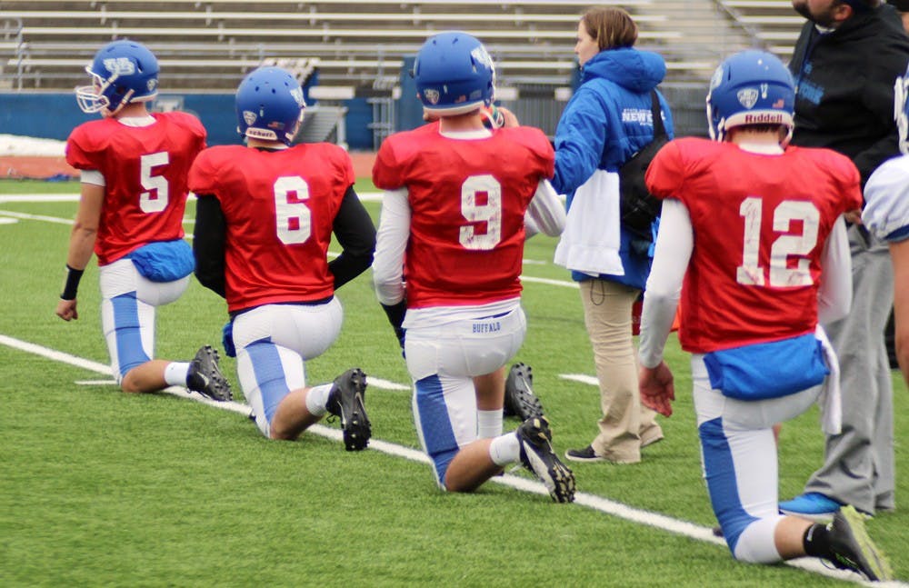 <p>Quarterbacks Tony Daniel, Collin Michael, Craig Slowik and Chris Merchant stretch during a practice on Wednesday. The team returns Daniel and senior Joe Licata, who is expected to assume the starting position after he recovers from off-season surgery.</p>