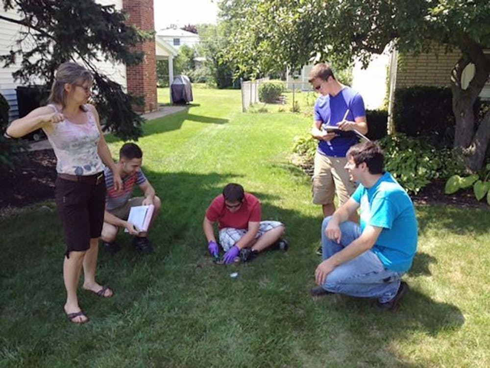 Members of Citizen Science Community Resources, from left to right, Jackie James-Creedon, Nick Bassisi, Jon Rusch, Alex Rusch and Andrew Baumgartner, take soil samples at a lawn in the Tonawanda area after high levels of benzene were detected in the air in 2004 and 2005. The benzene was traced to Tonawanda Coke, which produces coke to be used in the production of steel.
Courtesy of Citizen Science Community Resources