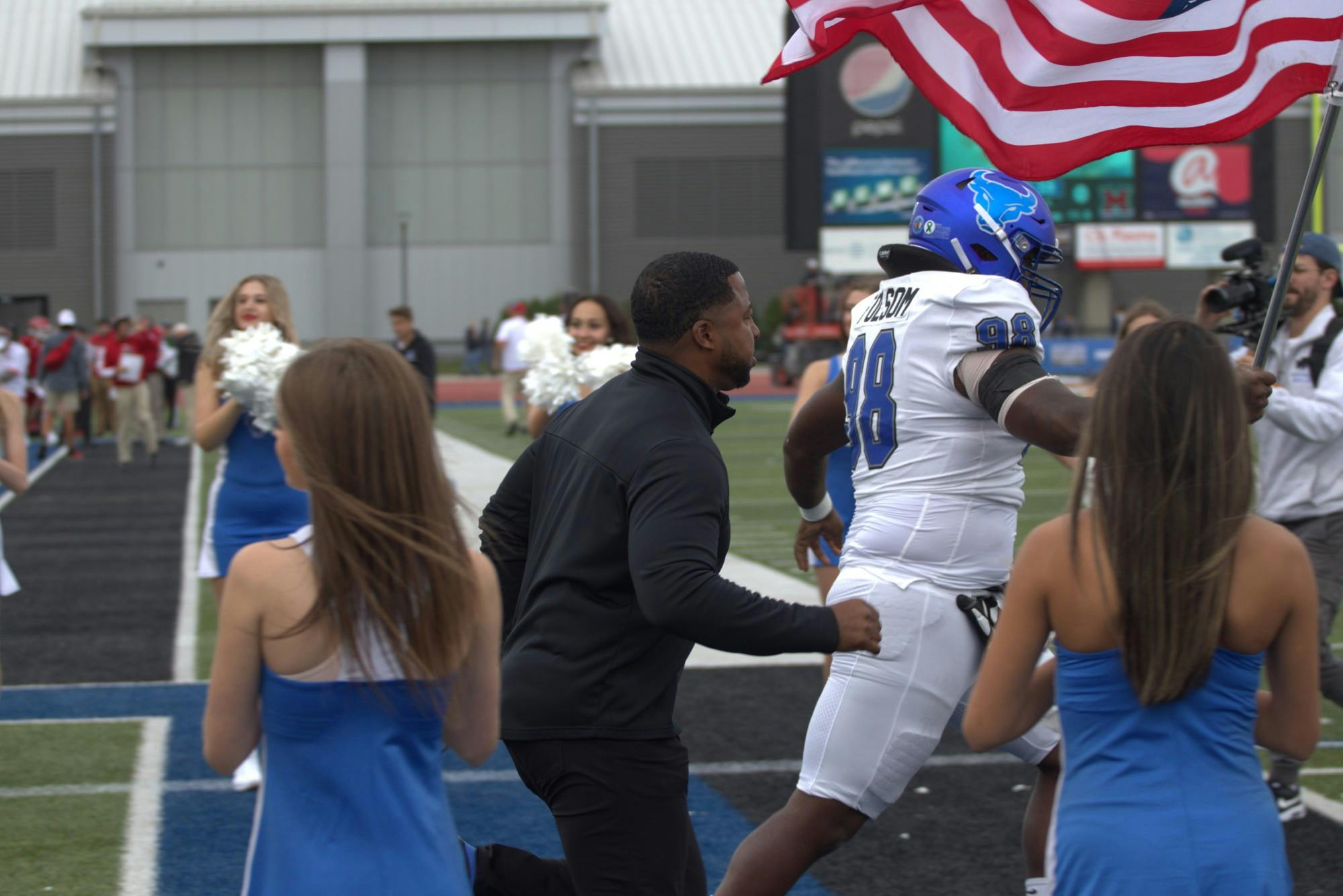 Bulls head coach Maurice Linguist runs out onto the field during a recent game.