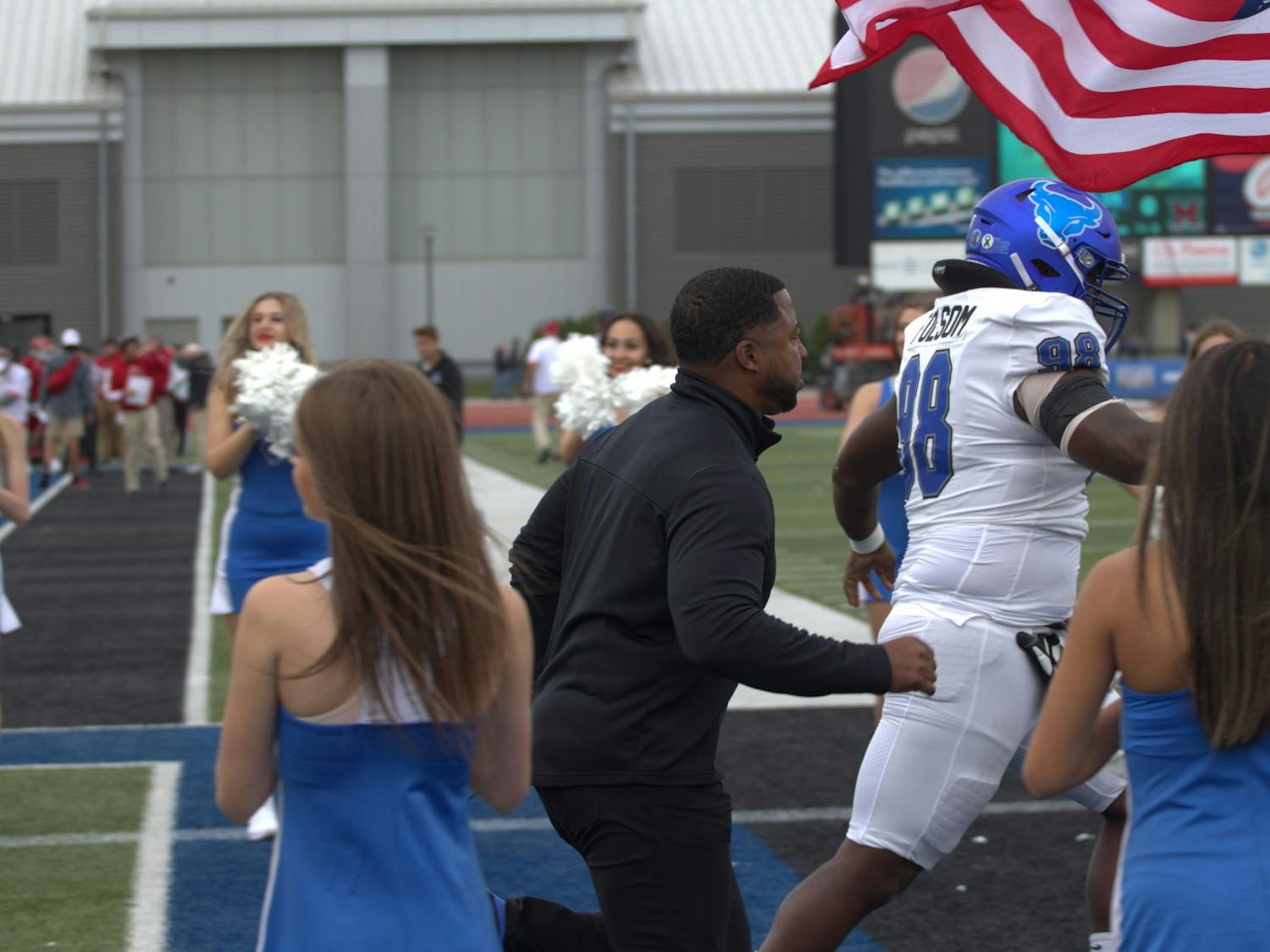 Bulls head coach Maurice Linguist runs out onto the field during a recent game.