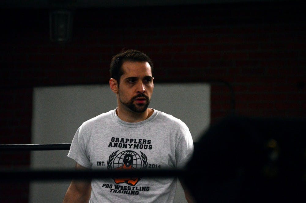 Brandon Thurston observes training at a Grapplers training session. Thurston is the head trainer at the gym, where he teaches a new generation of Western New York wrestlers.
