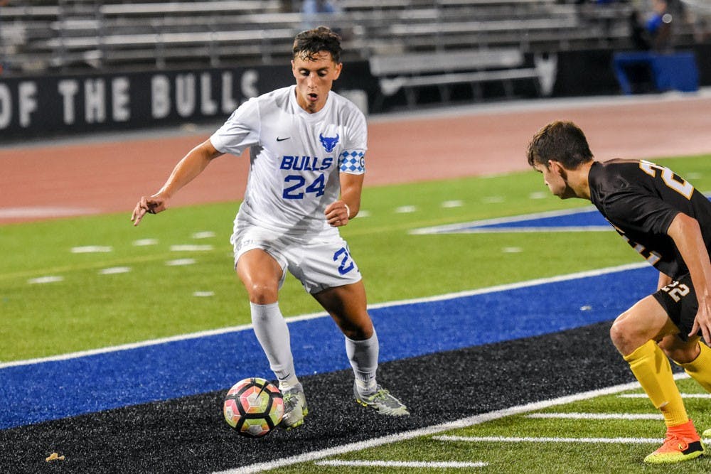 <p>Senior midfielder&nbsp;Braden Scales takes on a defender. He is the only fifth-year senior on UB men's soccer team.</p>