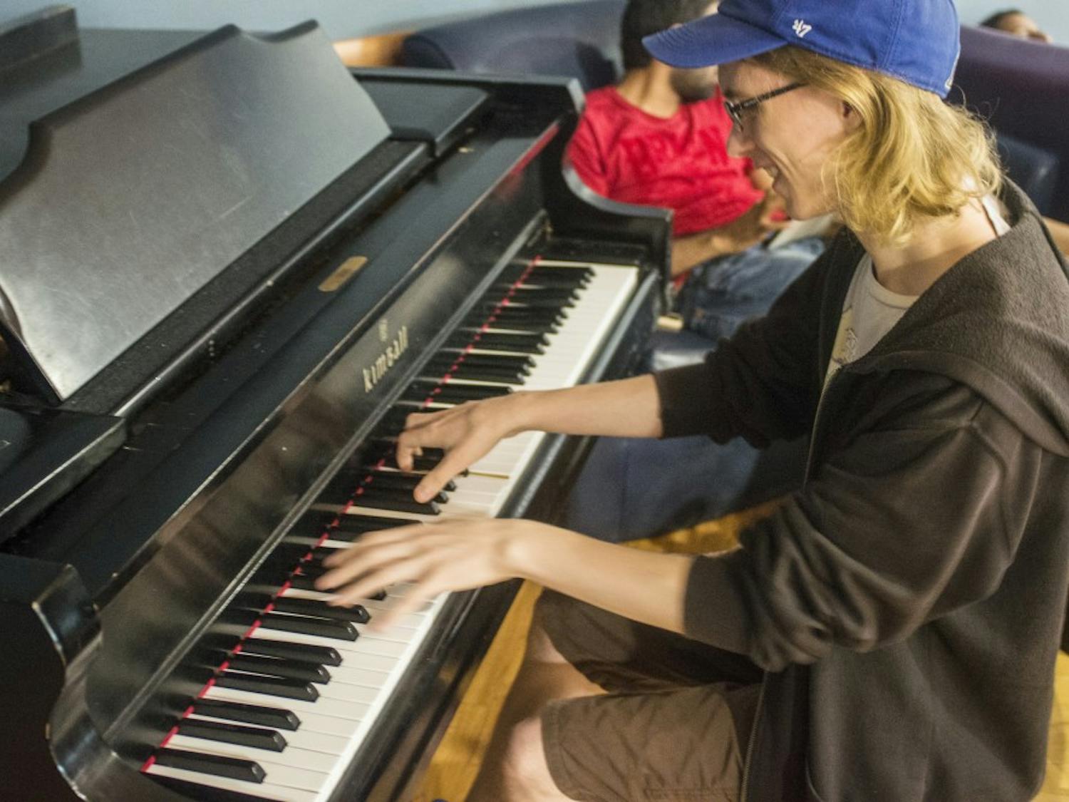 Alex Schwartz, the founder and president of the Student Association Piano Club, shows off his skills on the Flag Room piano, donated to the Student Union over 20 years ago by the Music Department.