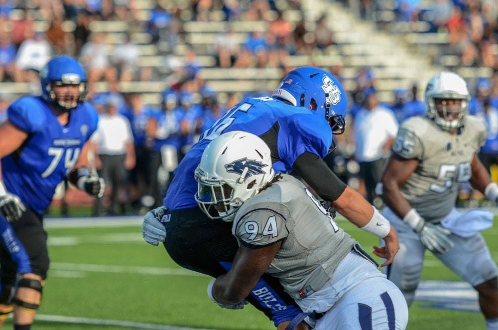 <p>Bulls senior quarterback Joe Licata gets hit by Nevada senior defensive end Lennie Jones. </p>