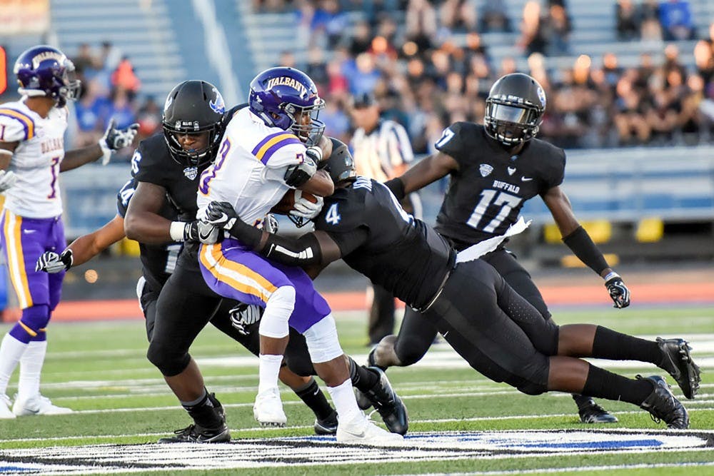 <p>Junior linebacker Khalil Hodge nails Ualbany player with a tackle. Hodge will be a major factor in the Bulls defense at Saturday's game.</p>