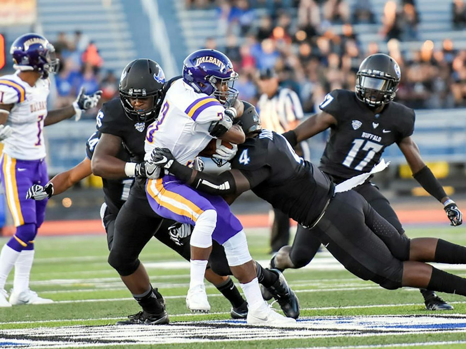 Junior linebacker Khalil Hodge nails Ualbany player with a tackle. Hodge will be a major factor in the Bulls defense at Saturday's game.