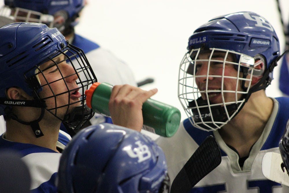 <p>Brad Bailey and Zach LaMacchia share a moment on the sideline during intermission. The Bulls defeated St. John Fisher 3-1 on Saturday. .</p>