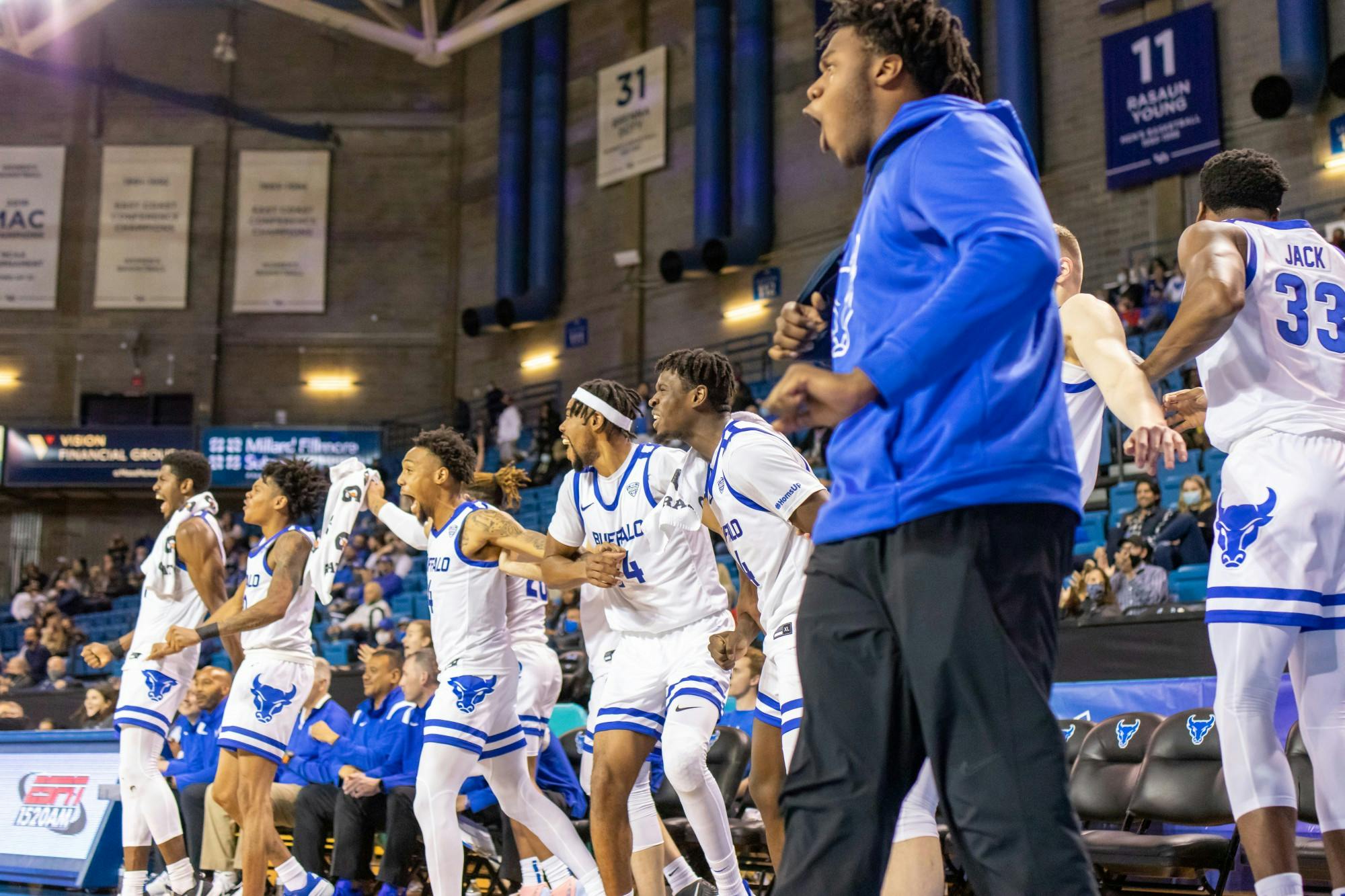 Members of the UB men’s basketball team celebrate during their 105-54 exhibition victory over Medaille Thursday.
