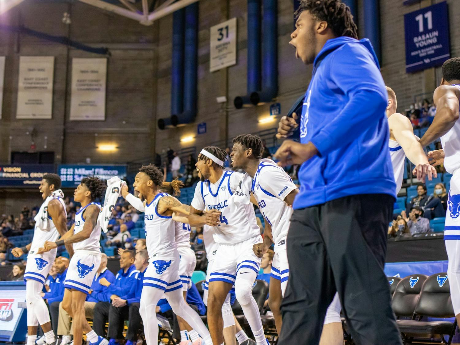 Members of the UB men’s basketball team celebrate during their 105-54 exhibition victory over Medaille Thursday.
