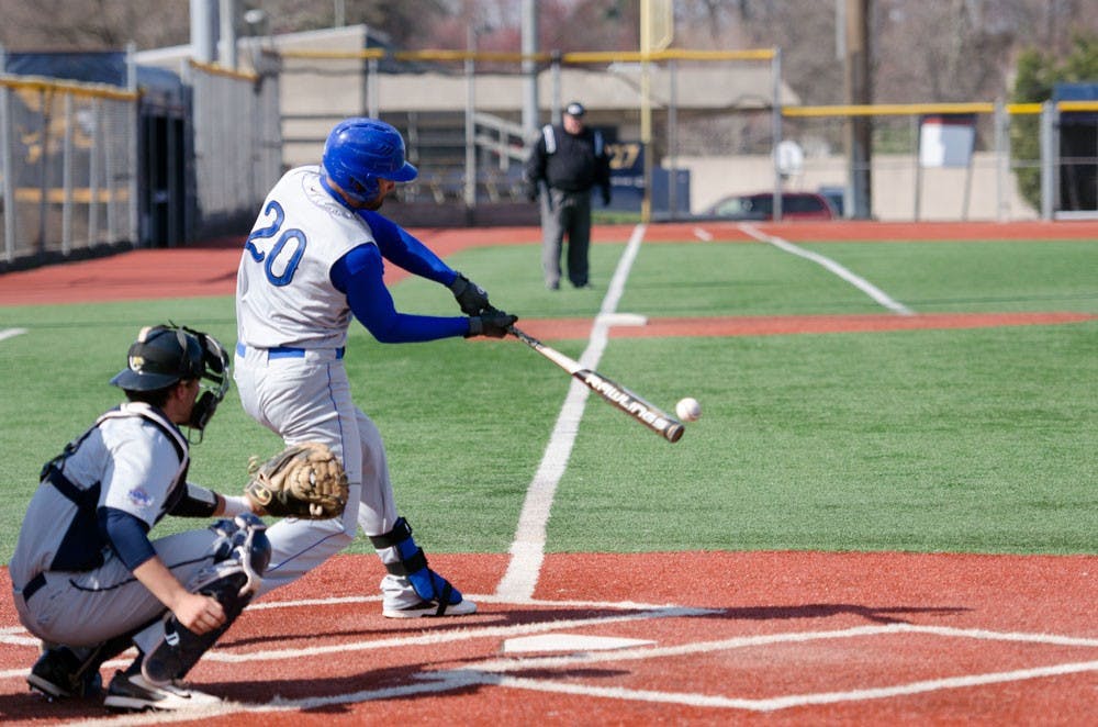 <p>Senior outfielder Mike Abrunzo makes contact with an opponent’s pitch. The Bulls won two of their three games against Toledo - their first series in MAC play.</p>