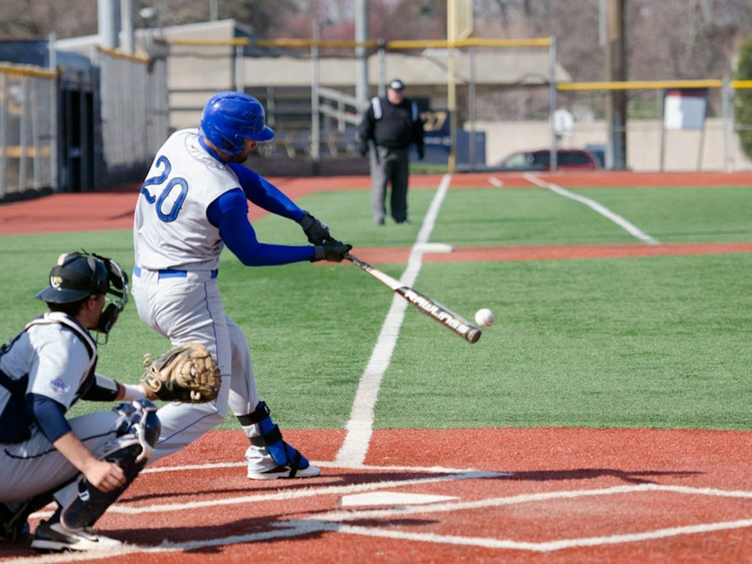 Senior outfielder Mike Abrunzo makes contact with an opponent’s pitch. The Bulls won two of their three games against Toledo - their first series in MAC play.
