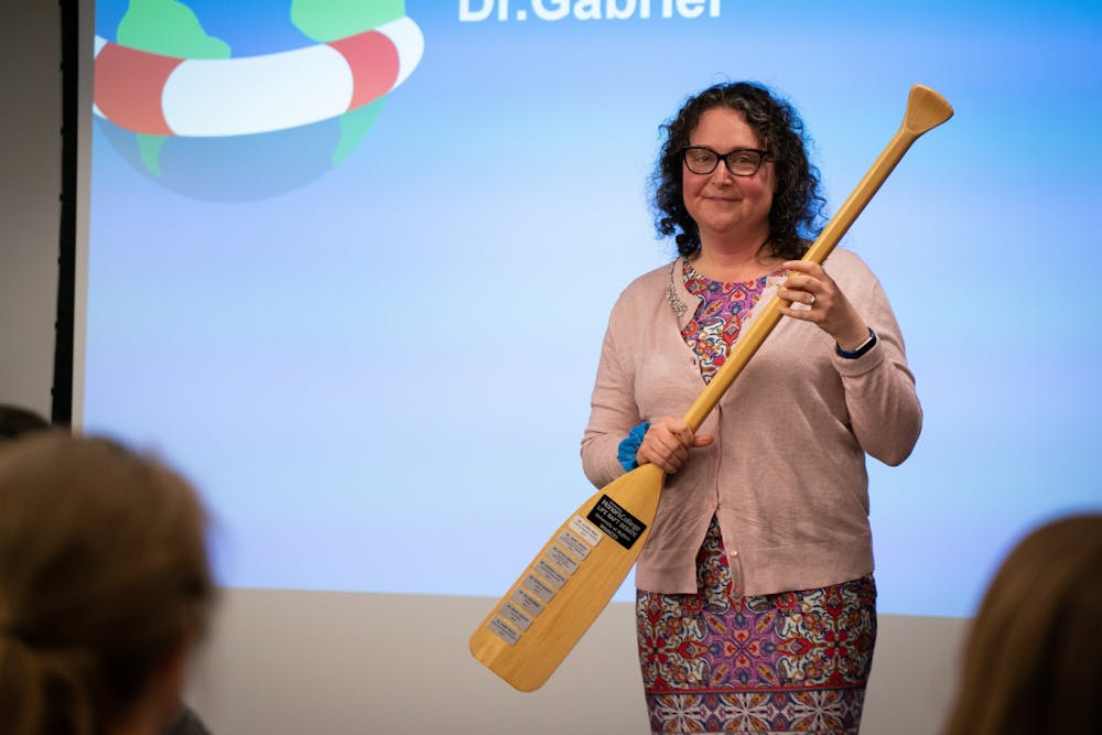 <p>Shira Gabriel, associate professor at University at Buffalo’s Department of Psychology, accepts the trophy for winning the Life Raft debate.</p>