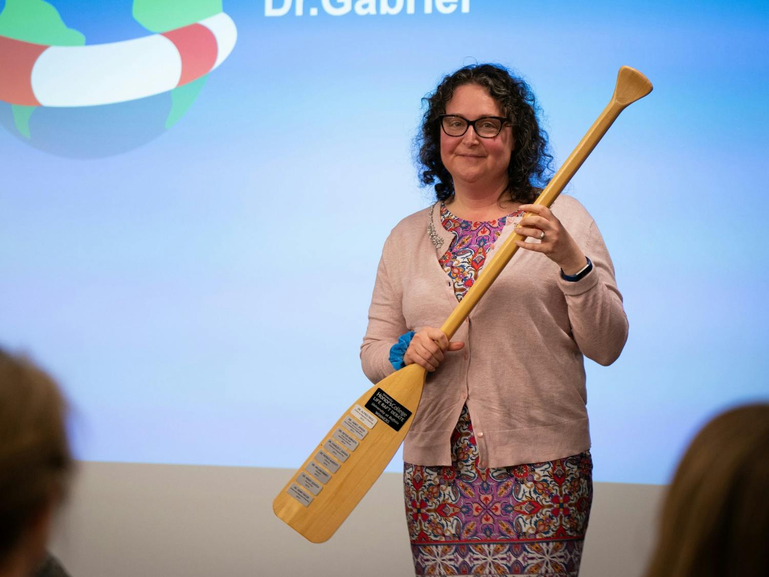 Shira Gabriel, associate professor at University at Buffalo’s Department of Psychology, accepts the trophy for winning the Life Raft debate.
