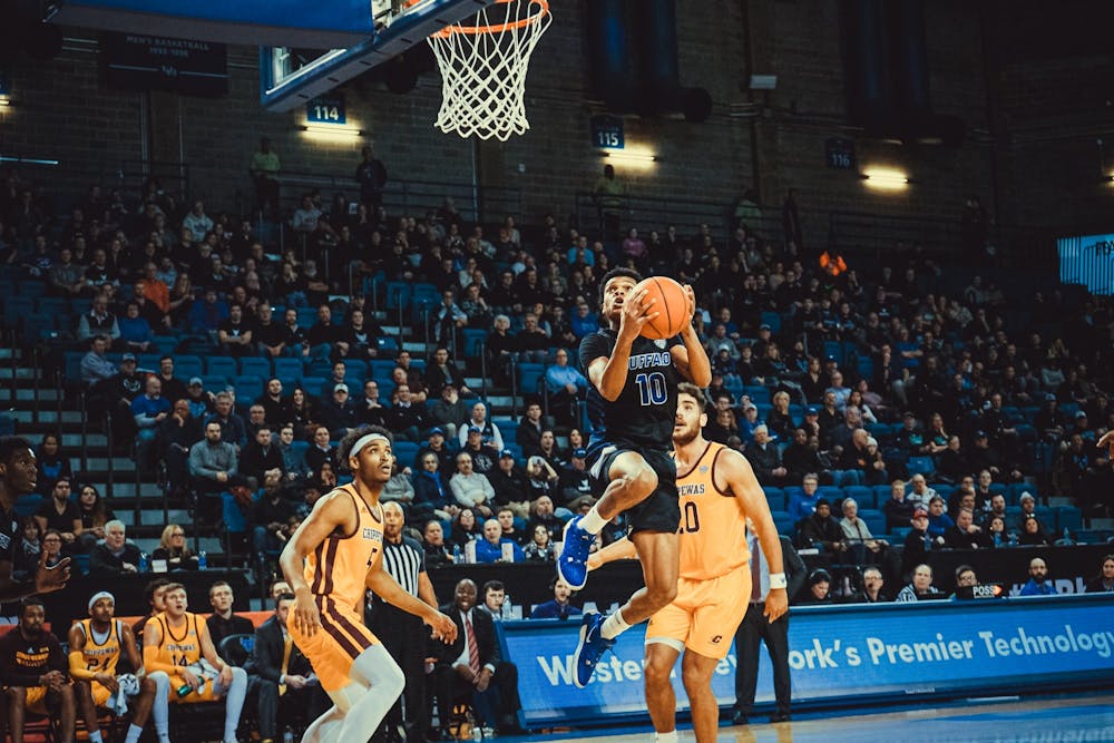 <p>Ronaldo Segu splits two Central Michigan defenders.</p>