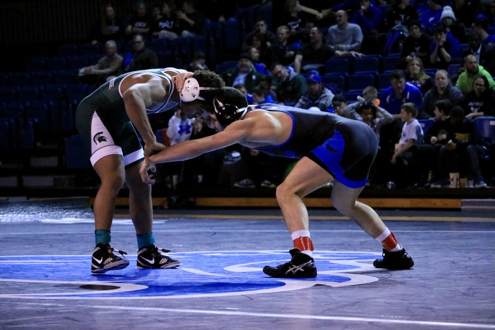 <p>Senior 141-pounder Jason Estevez locks up with an opponent. Estevez is 7-7 on the year but is coming off a decisive victory against Northern Illinois.</p>