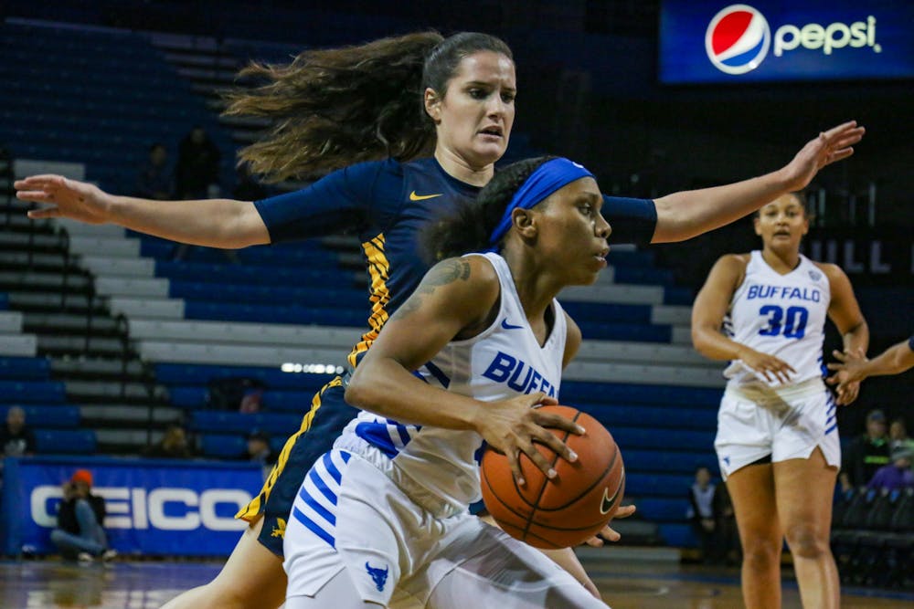 Dyaisha Fair protects the ball from a Canisius defender Tuesday night during UB's victory.