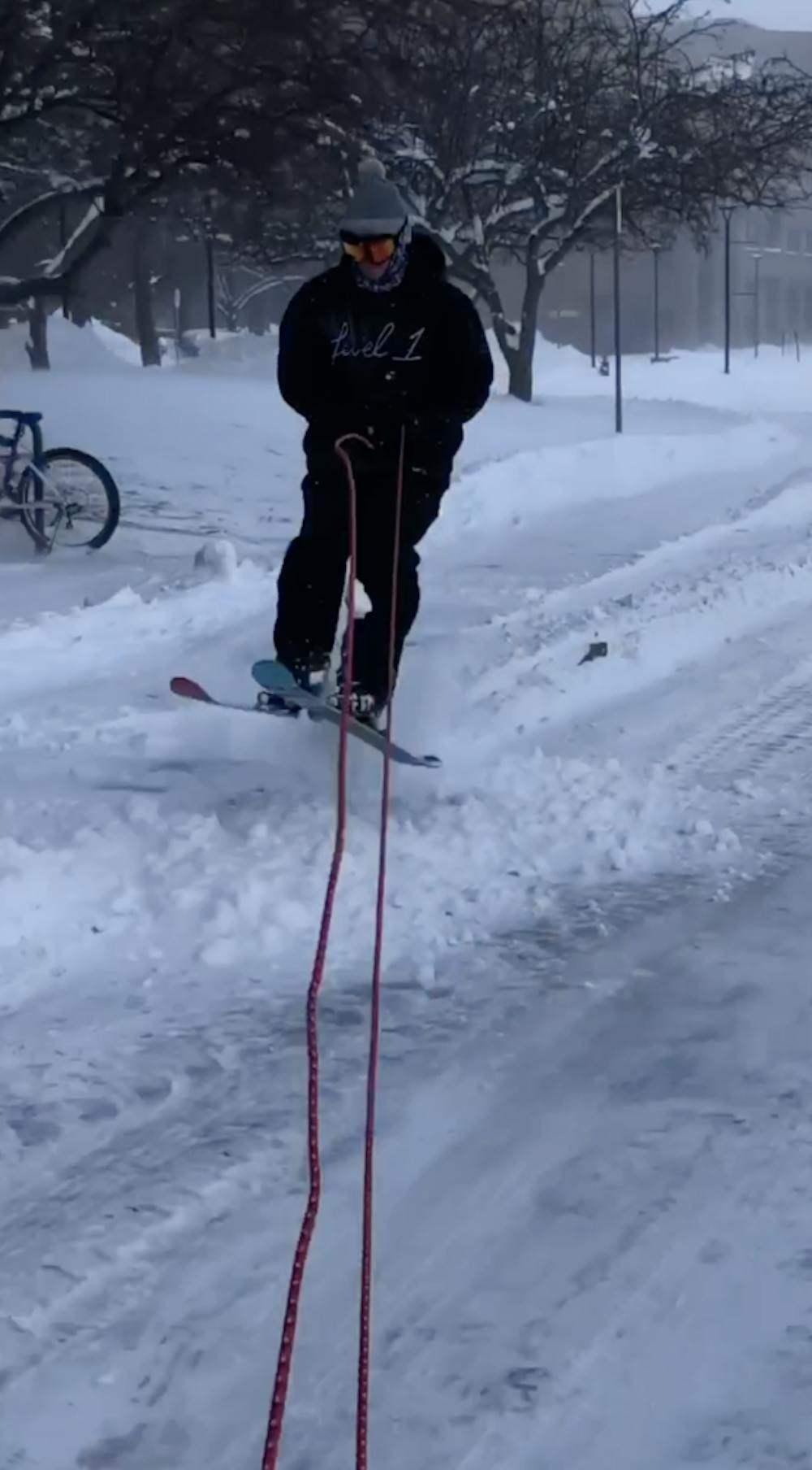 <p>Freshman Ben Meister skis behind his friend’s jeep on North Campus. Meister and three of his friends became internet famous after their ski adventure during Wednesday’s snow day.</p>