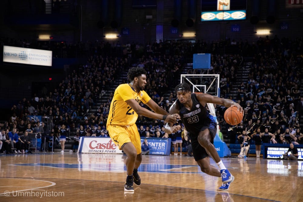 <p>Senior forward Nick Perkins drives for two of his career-high 27 points in front of a sold-out Alumni Arena on Friday.</p>