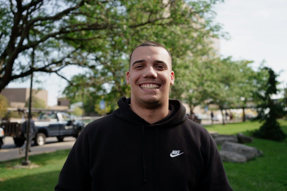 <p>Anthony Vargas smiles in front of the Student Union.</p>