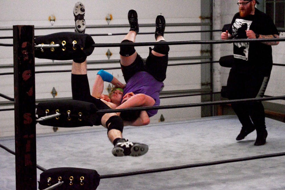 Vincent Piazza delivers a superplex to his opponent during a training session. Piazza wrestles as Vinnie Moon and hopes to sell his signature bandanas at upcoming shows.