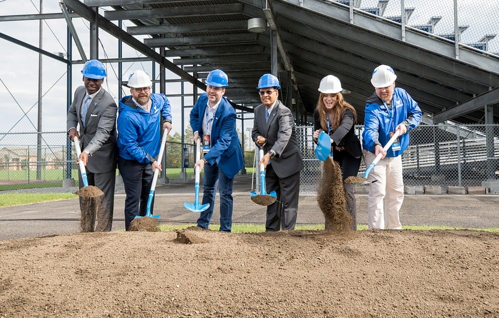 <p>UB President Satish Tripathi, Director of UB athletics Allen Greene and other contributors dig into where the field house will be as&nbsp;part of the official breaking ground ceremony.&nbsp;</p>