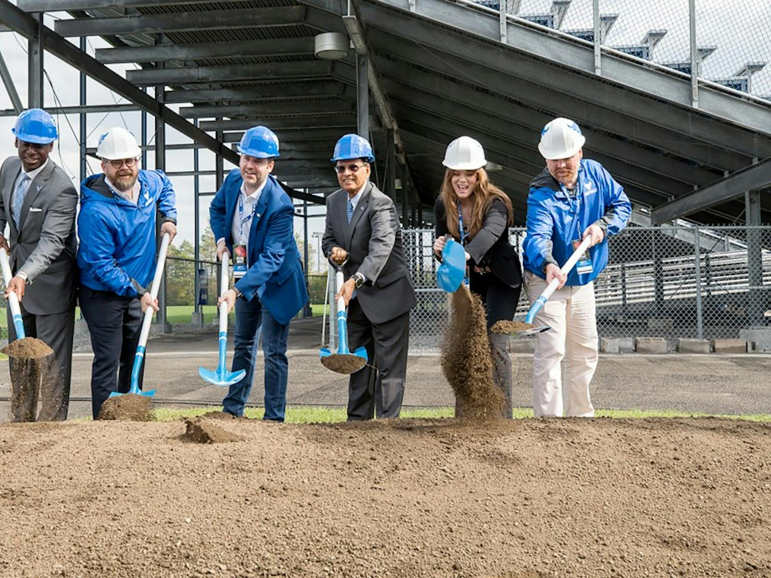 UB President Satish Tripathi, Director of UB athletics Allen Greene and other contributors dig into where the field house will be as part of the official breaking ground ceremony. 