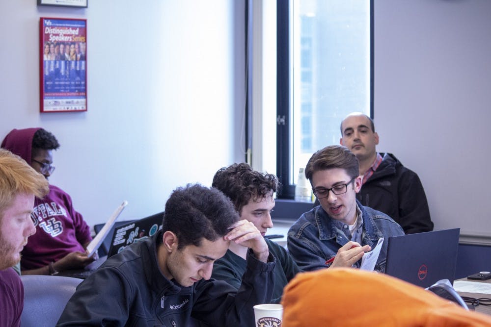 <p>Student Association senators look over SA senate chairperson Eric Weinman’s proposed Rules of Procedures handbook at the Friday meeting.</p>