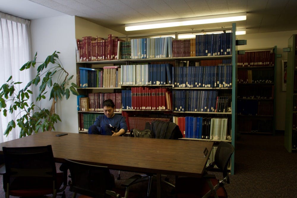 <p>A student reads a book inside the Music Library alone. Faculty and students still have concerns over the library's future, following the retirement of the library’s archivist.</p>