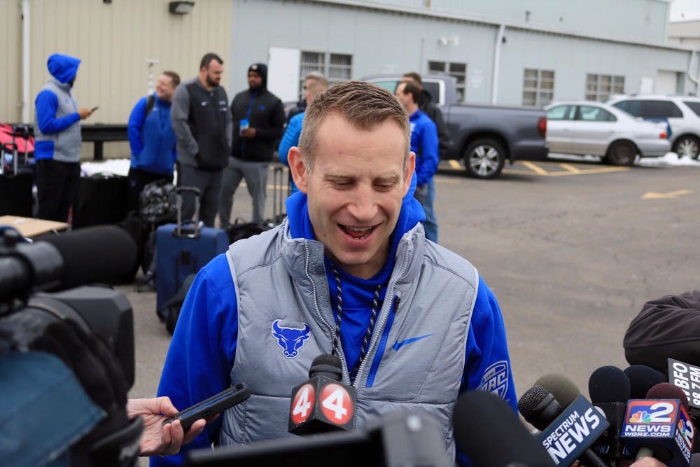 <p>Bulls head coach Nate Oats (side) and junior guard CJ Massinburg (side) talk to the media outside Prior Aviation before the Bulls left for Boise, Idaho. The Bull will take on projected top-five pick Deandre Ayton and the Arizona Wildcats.</p>