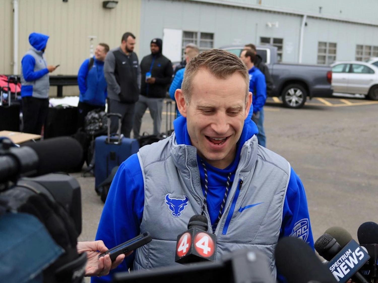 Bulls head coach Nate Oats (side) and junior guard CJ Massinburg (side) talk to the media outside Prior Aviation before the Bulls left for Boise, Idaho. The Bull will take on projected top-five pick Deandre Ayton and the Arizona Wildcats.