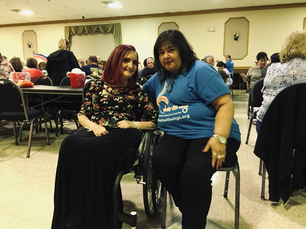 <p>Natalie Barnhard (left) and Mary Lynn Barnhard (right) pose in front of the crowd. Wheels With Wings held its fourth annual meat raffle on Friday giving away items such as 12-14 lbs turkeys.</p>