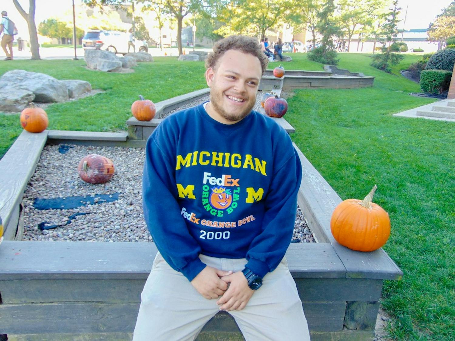 Chris Banks, also known as Young Scholar, sits outside of the Student Union.