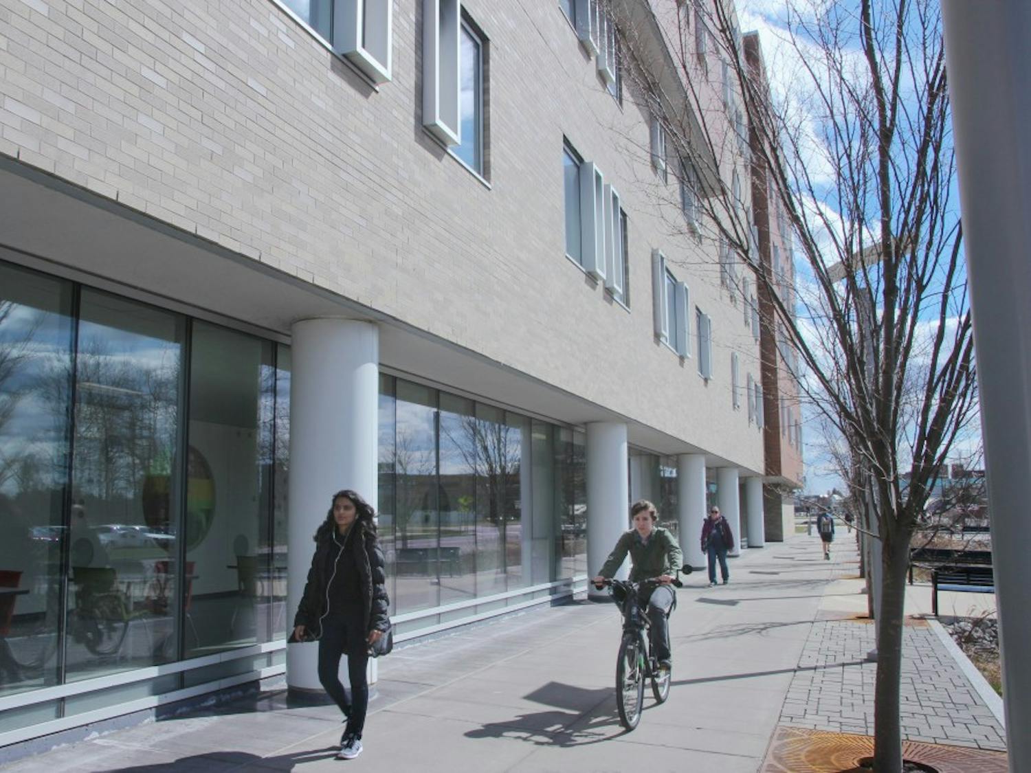 UB students walk outside Greiner Hall, a residence hall for sophomores. 