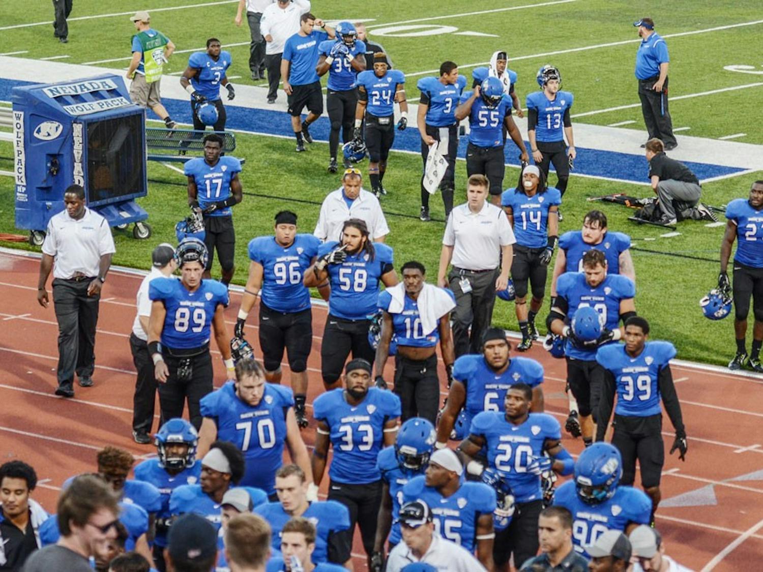 The football team walks off the field after a game against Nevada in September of 2015. The team spent more than $70,000 staying in hotels the nights before home games in 2014.&nbsp;