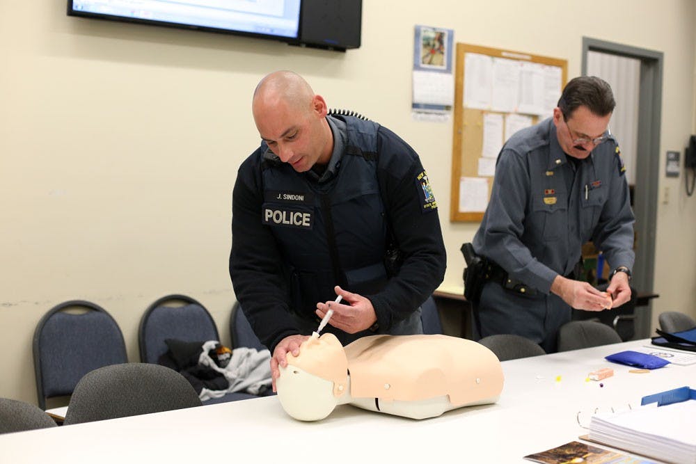 <p>UPD officer John Sindoni administers Narcan on a dummy last April. Sindoni was one of three UPD officers recognized at SUNY Chiefs Association Awards last month.</p>