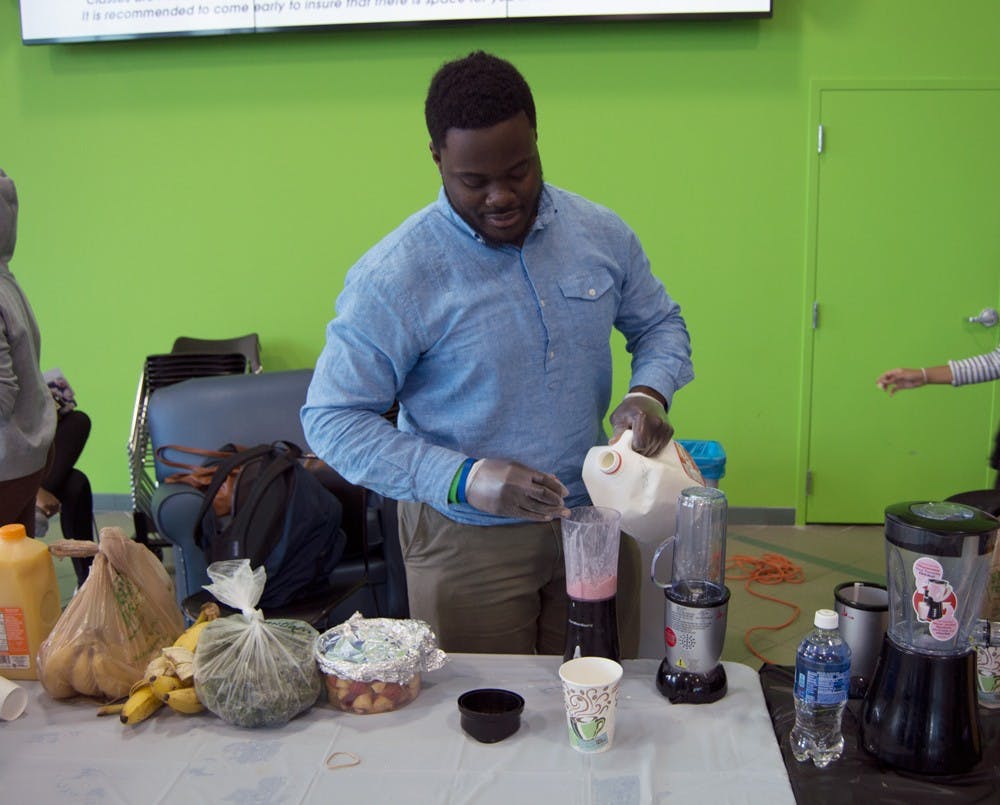 <p>Caribbean Student Association Vice President Shawn Gibson makes a smoothie, which is one event the CSA offered this week in the Student Union. All of the events were intended to encourage students to learn more about Caribbean culture.</p>