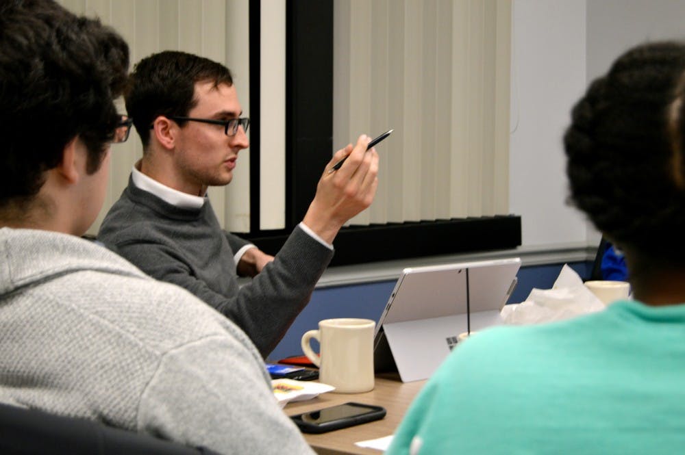 <p>Speaker of the&nbsp;SA Assembly Mike Brown and assembly&nbsp;members discuss a proposed 18 and up bar near South Campus. While some students could see benefits to the proposed bar, the Assembly passed a resolution opposing it six to two, with three members abstaining.</p>