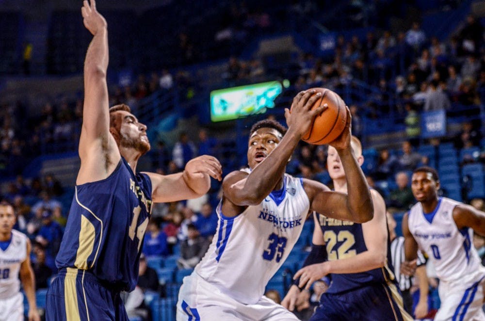 <p>Freshman forward Nick Perkins posts up a Pittsburgh at Bradford defender in a victory at Alumni Arena earlier this season. Perkins had 13 points and four rebounds before fouling out in a loss against Western Michigan Saturday.&nbsp;</p>