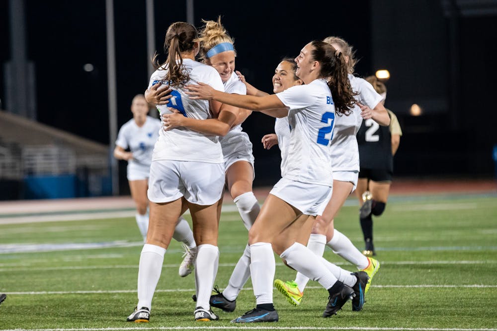Gianna Yurchak (9), Kaya Schultz (24) and members of the women’s soccer team celebrate after scoring a goal over the weekend.
