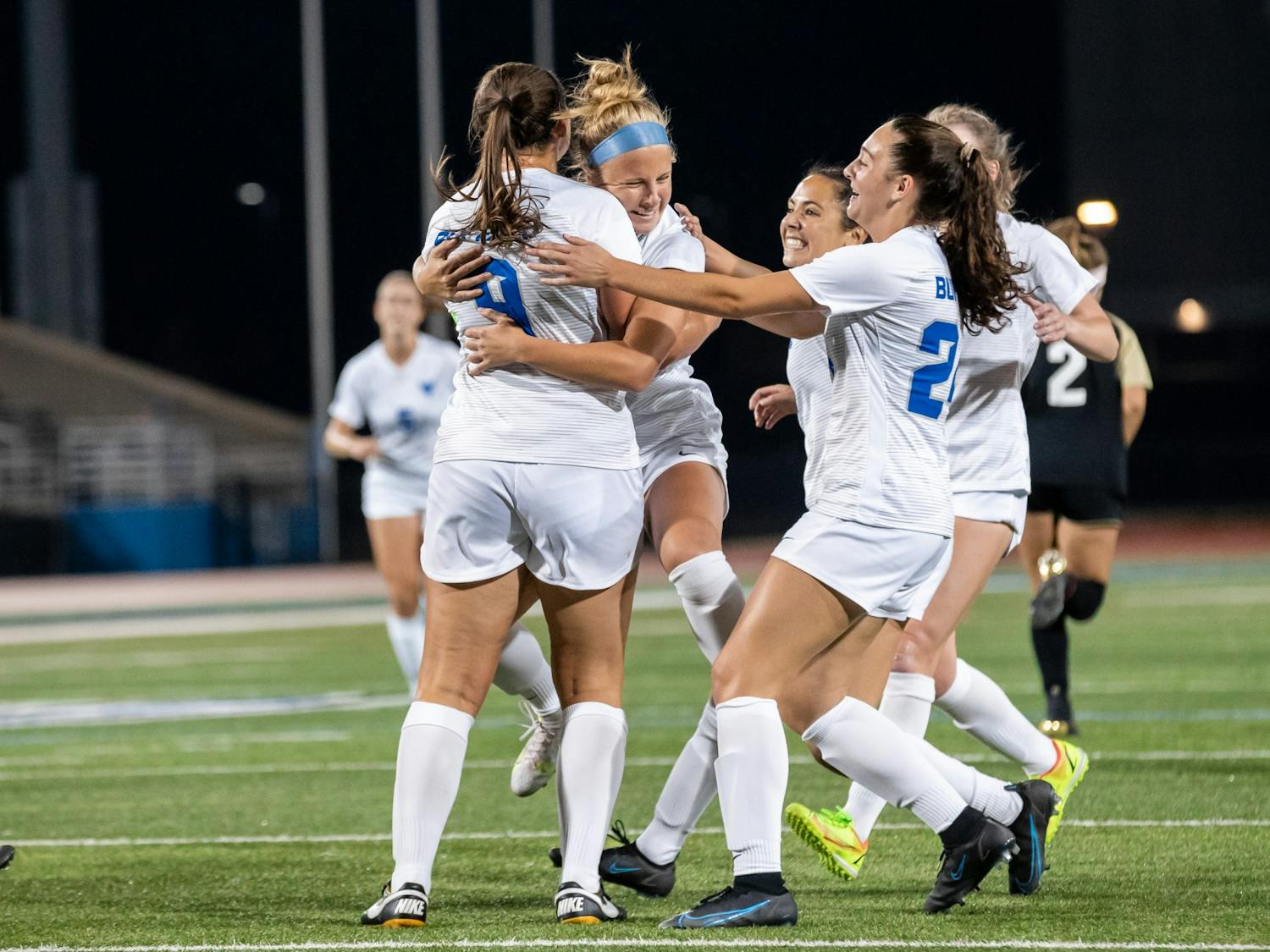 Gianna Yurchak (9), Kaya Schultz (24) and members of the women’s soccer team celebrate after scoring a goal over the weekend.