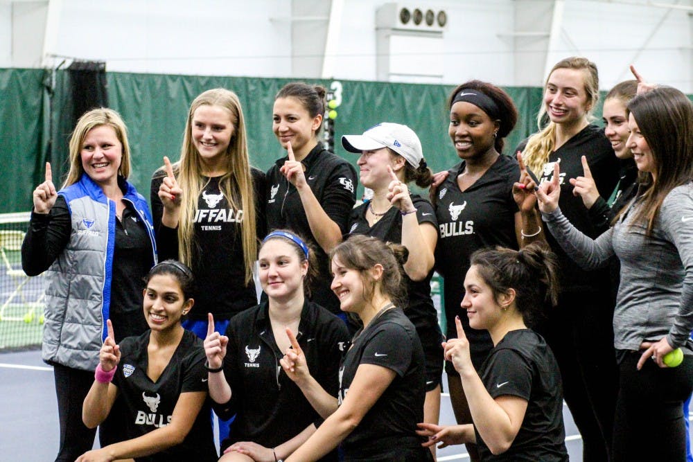 The Bulls celebrate with a horns up after a win. The women’s tennis team will try to win consecutive MAC championships this weekend in Muncie, Indiana.