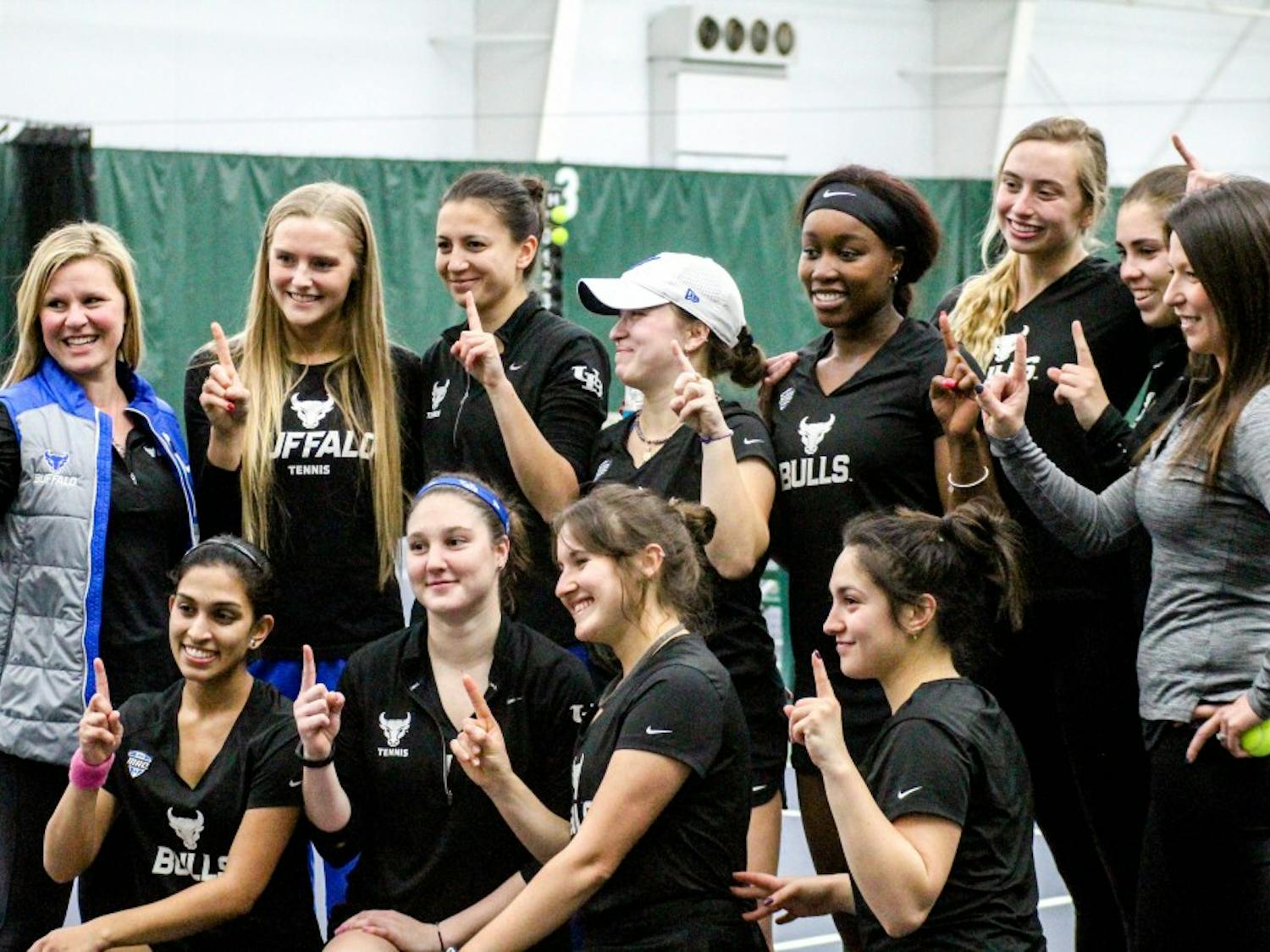 The Bulls celebrate with a horns up after a win. The women’s tennis team will try to win consecutive MAC championships this weekend in Muncie, Indiana.