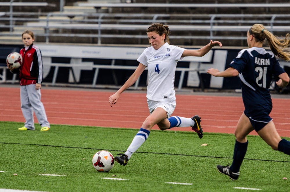 <p>Senior defender Angel Hart hits a cross. Hart has proven to be key in the women’s soccer defensive line.</p>