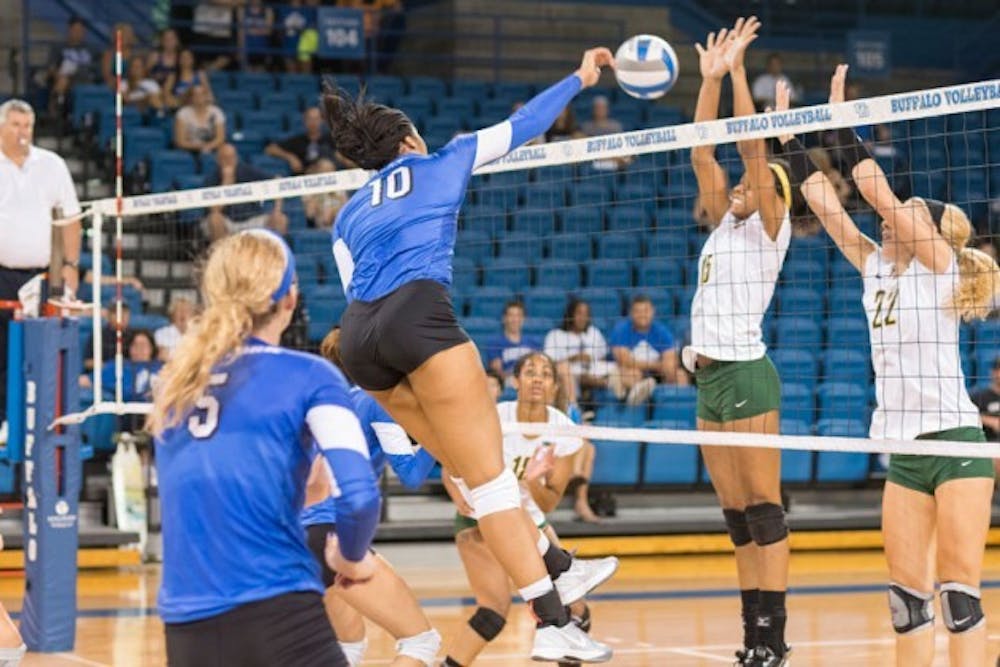 Junior middle blocker Akeila Lain sets up a spike. The volleyball team was perfect in its three games this weekend, going 3-0 to win the UIC Tournament Championship.