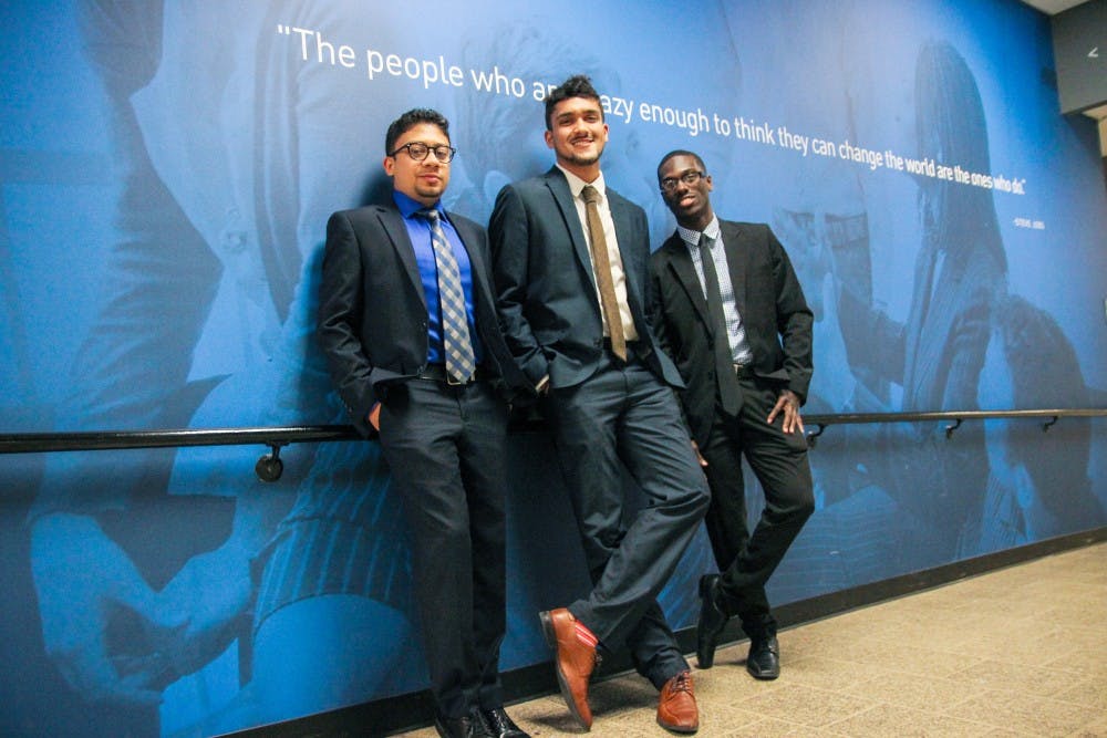 <p>(left to right) Abid Alam, Hnu Thaper and Elijah Tyson pose in front of the Blackstone Launchpad office in the Student Union. The trio founded Coldspace to create a solution to food storage on campus.</p>