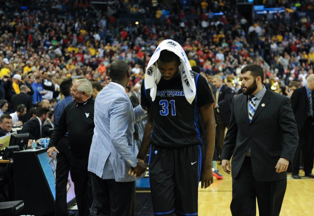 <p>Raheem Johnson walks out of Nationwide Arena after UB's 68-62 loss to West Virginia at the NCAA Tournament. Johnson and teammate Mory Diane were suspended for the first regular season game.&nbsp;</p>