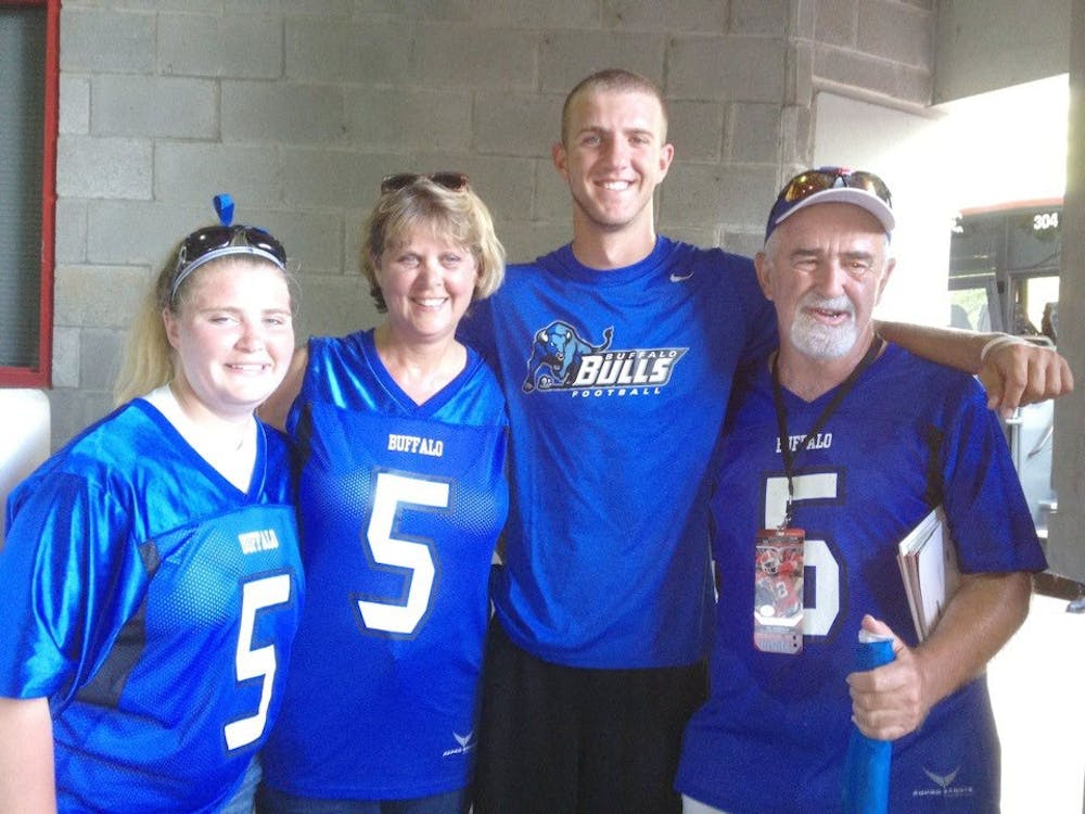 <p>(from left to right) Carley, Rose, Tony and Jack pose for a photo while all donning Buffalo gear.</p>