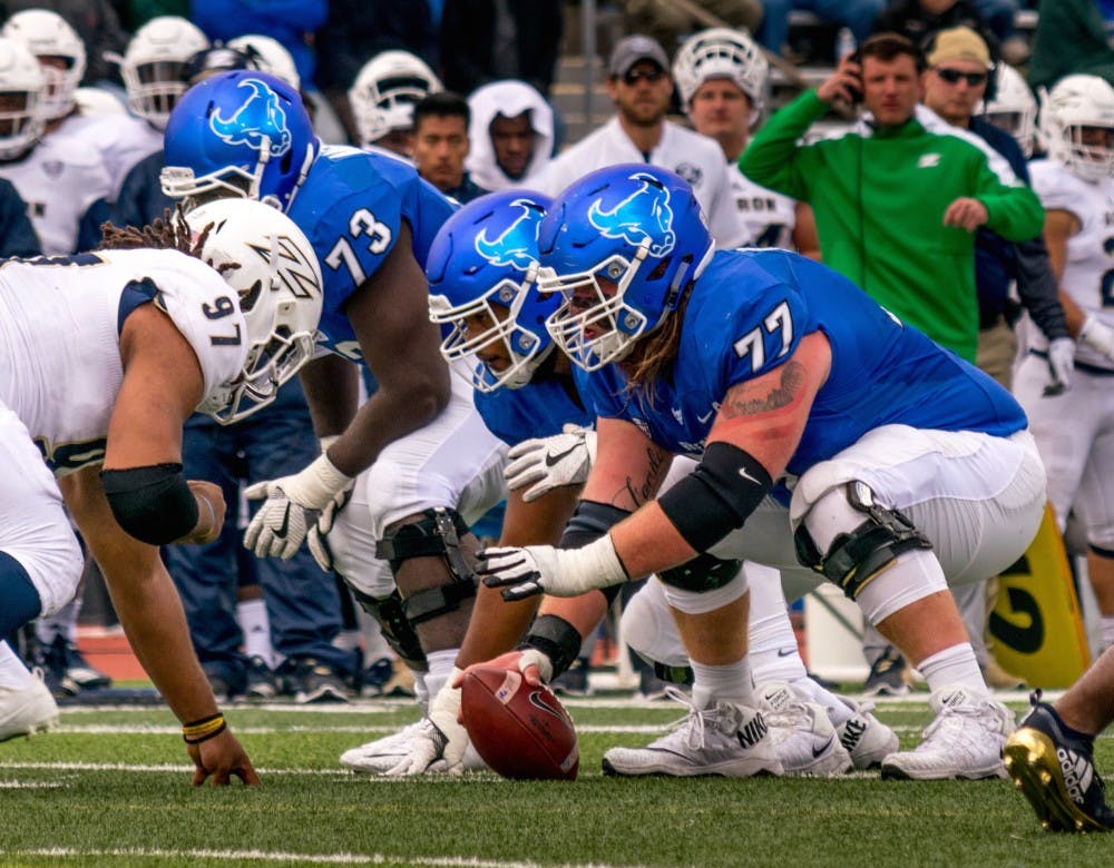<p>James O’Hagan prepares to snap the ball. The center has been named a midseason All-American by USA Today and Pro Football Focus.</p>